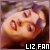 Pixelated image of a person's face with visible eyes, nose, and mouth against a blurred background, featuring text 'LIZ FAN' at the bottom.