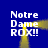 Blue background with four identical text blocks reading "Notre Dame ROX!!" and two yellow animated light beams crossing between them.