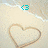A static pixelated image shows a light beige background with a large brown heart outline and small cyan circular shapes near the top center.
