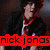 Pixelated image of a person with dark hair wearing a black jacket over red clothing, standing against a dark background with red text overlay reading 'nick jonas' in lowercase.