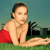 A pixelated image of a person in a red swimsuit lying on grass with a blurred background.