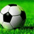 Static pixelated image of a soccer ball on green grass background with visible dithering and anti-aliasing effects.