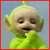 Pixelated green character with large ears, closed eyes, and a smiling mouth against a light blue background with red border.