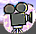 Pixelated film camera icon with two reels and a rectangular body, surrounded by pink and white starry aura on light purple background.