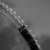 A grayscale pixelated image of a diagonal dark shape with scattered light pixels against a gradient background.