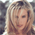 Static pixelated image of a person with light brown hair and a neutral expression against a blurred background.