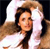 A pixelated image shows a person with long dark hair wearing a white top, positioned against a light background with a dark area on the right side.