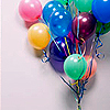 A cluster of glossy, multicolored balloons tied together with striped ribbons against a light gray background.