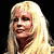 Static pixelated image of a person with long blonde hair against black background, rendered in low-resolution style typical of early internet icons.