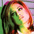 A pixelated image of a person with long hair and colorful highlights, positioned next to green text on a dark background.