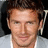 A pixelated image of a person with short brown hair wearing a light gray shirt, next to green background with orange text reading 'david + beckham = HOT'.