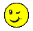 Pixelated yellow circular face with one open eye, one winking eye, and a curved smile on white background.