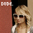 Pixelated image of a person with blonde hair and sunglasses, wearing a white top against a red background, with 'DUDE.' text above.