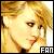 Pixelated static icon of a person with blonde hair and light skin tone, featuring visible text "FAN" in the bottom-right corner.