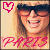 A pixelated image of a person with long hair wearing dark sunglasses, smiling broadly with visible teeth, featuring pink text and a heart symbol.