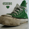 Green high-top sneaker with white laces and a worn brown sole, displayed against a light background with 'GREEN' text and a green heart icon above it.