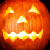 A pixelated orange pumpkin with glowing eyes, nose, and mouth on a black background, next to text reading 'happy halloween 2004' in matching style.