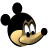 Pixelated cartoon head with large black ears, tan face, white eyes with black pupils, and a black nose on a gray background.