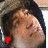 A person wearing a dark hooded garment and light-colored cap appears in three with changing facial expressions and a heart symbol