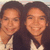 Two people with long dark hair wearing white shirts smile in a of four showing slight variations
