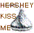 Pixelated static icon featuring brown text and a Hershey's Kiss chocolate with scattered colored pixels on white background.