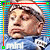 A 50x50 pixel animated contact sheet showing two frames of a character with light brown hair wearing a blue shirt, displayed on a striped background with colored border markers.