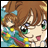 A pixelated anime-style character with brown hair and green eyes on the left, next to a black background with white text reading "Anime IM" above smaller text "COM" on the right.
