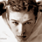 Static 48x48 pixel icon showing a close-up of a person's face with brown hair and neutral expression, rendered in low-resolution grayscale tones on white background.