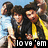 Three people in dark clothing pose closely together against a light blue background with a black banner displaying 'love 'em' text at the bottom.