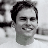 Black-and-white pixelated portrait of a smiling person with short dark hair on left, green text 'OriginalIcons.com' on right against solid background.