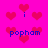 A bright pink background features scattered red heart shapes and blue text reading 'popham' with lowercase 'i's, arranged in a repeating pattern.