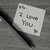 A collage of six distinct visual elements including a note, heart symbol, book cover, shoe sole, stick figures, and text.