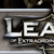 A pixelated logo for 'League of Extraordinary Gentlemen' with metallic text and ornate design elements on a gray background.