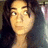 Pixelated static image of a person with long dark hair and light skin, wearing a sleeveless top against a blurred background.