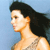 Pixelated profile view of a person with long dark hair against a light blue background, wearing a sleeveless top with a patterned design.