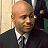 A 48x48 pixel buddy icon split into two frames showing a man in business attire on the left and green text "Original Icons .com" on a dark background on the right, with visible pixelation and dithering effects.