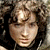 A 50x50 pixel buddy icon split into two vertical sections: a grayscale portrait of a person with curly hair on the left and green text reading "Original Icons .com" on a dark green background on the right.