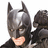 Pixelated image of Batman in a dark cowl with pointed ears, wearing a black suit and cape against white background.