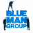 Static pixelated icon featuring blue text "BLUE MAN GROUP" with dark silhouettes of figures positioned around the letters, set against a white background.