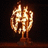 Pixelated golden trophy with a curved base and central column, set against dark background.