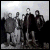 Black-and-white pixelated image of a group of people standing together on the left, with "DAVE MATTEWS BAND" text in pixelated font on the right.