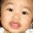 Pixelated close-up of a child's face showing eyes, nose, mouth, and partial hair with visible pixelation and color blending.