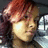 Pixelated static image of a person with reddish-brown hair, light skin tone, and closed eyes against dark background.