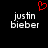 Black background with white pixelated text 'justin bieber' on left and right, red pixelated heart symbol above text.