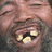 A pixelated close-up of a person's face with a wide open mouth showing teeth and a black background with white text reading don't worry just smile.