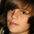 A pixelated image of a person with brown hair and light skin, featuring pink text overlay in the right