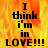 A pixelated text-based image with fiery orange and yellow background displaying 'I think i'm in LOVE!!!' in black block letters, split into two showing identical content