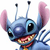Pixelated blue alien with large black eyes, pink inner ears, two antennae, and a wide open mouth showing teeth and tongue.