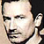 Pixelated close-up of a person's face with visible facial features and partial clothing, displayed as a static 50x50 icon.