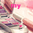 A hand holds a lip gloss tube with pink and purple eyeshadow visible in the background, overlaid with changing text.